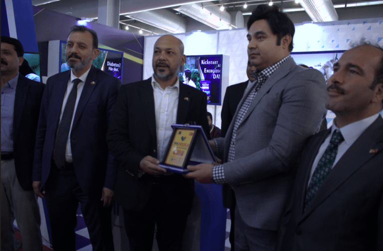 CEO receiving award at Lahore supplements exhibition